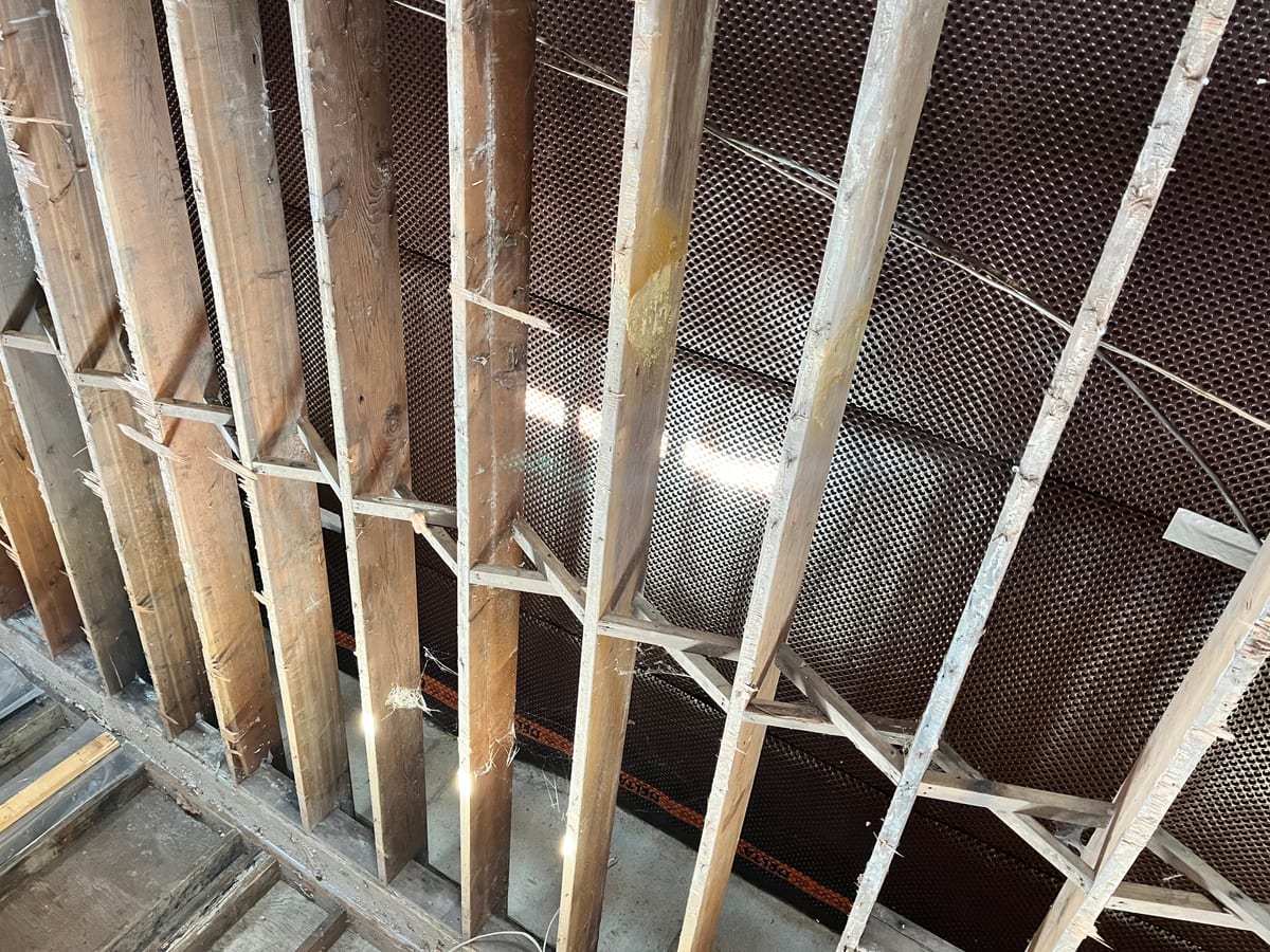 Crawlspace floor joists with drainage matting installed by Crawlspace Specialists Surrey